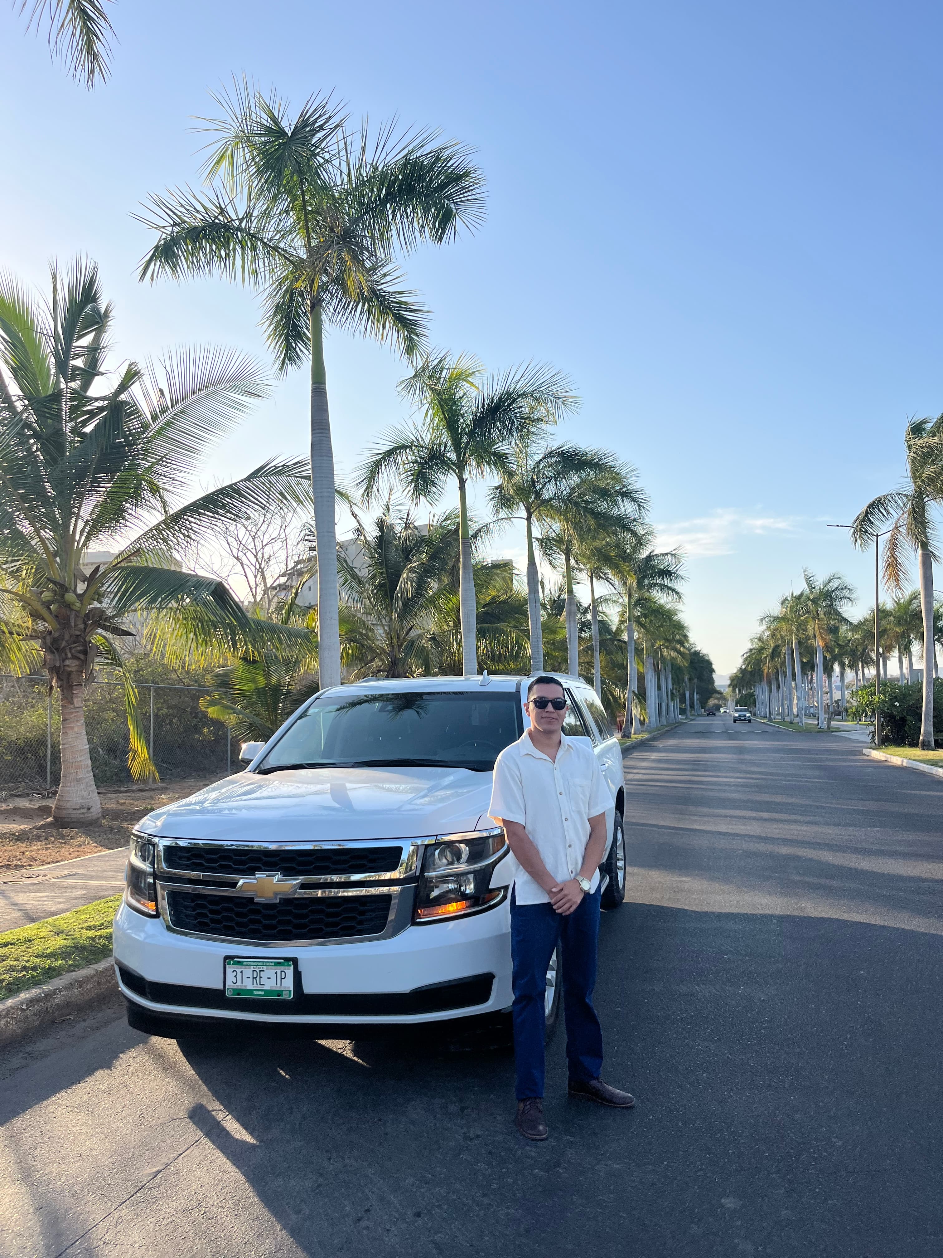 Carlitos — your chauffeur, on the palm-lined boulevard